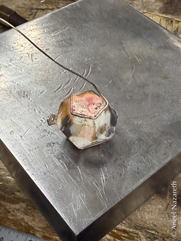 The top of the dodecahedron has some thin silver wire wrapped around it